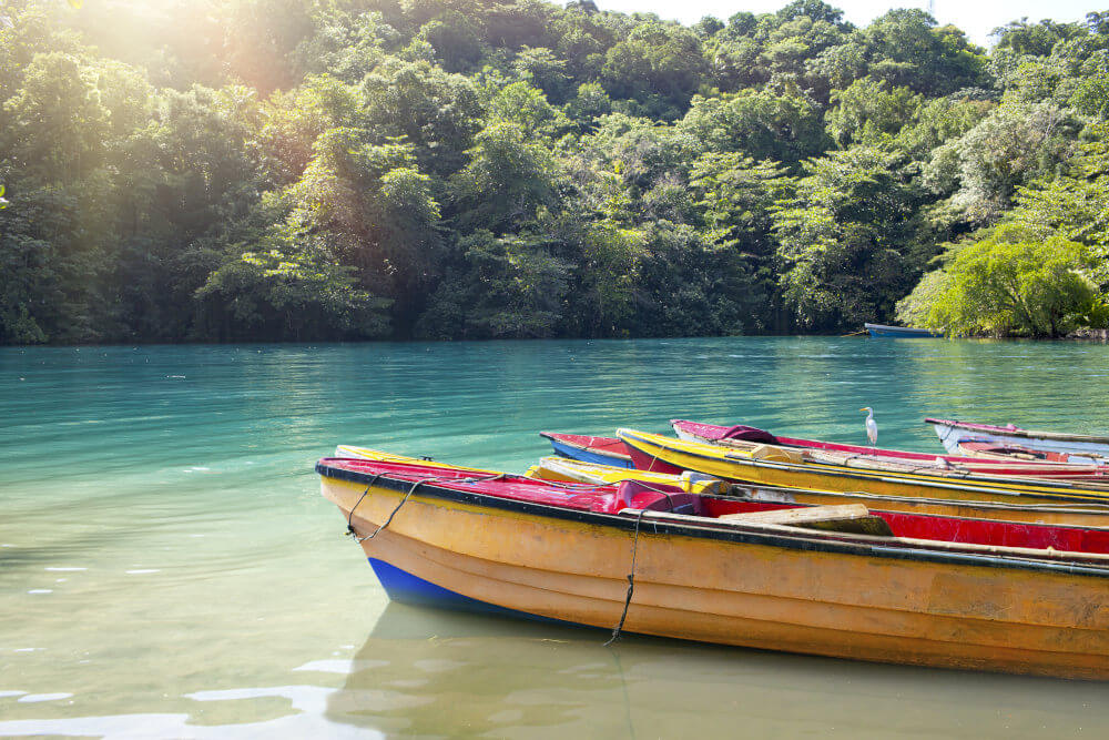 National Boats Of The Blue Lagoon, Jamaica A Tropical Landscape. Blue lagoon